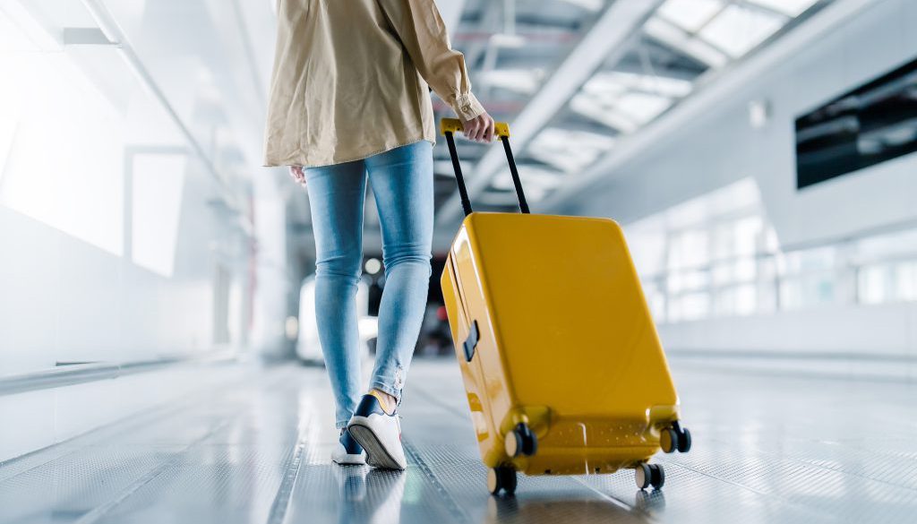 International airport terminal. Asian beautiful woman with luggage and walking in airport