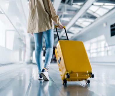 International airport terminal. Asian beautiful woman with luggage and walking in airport